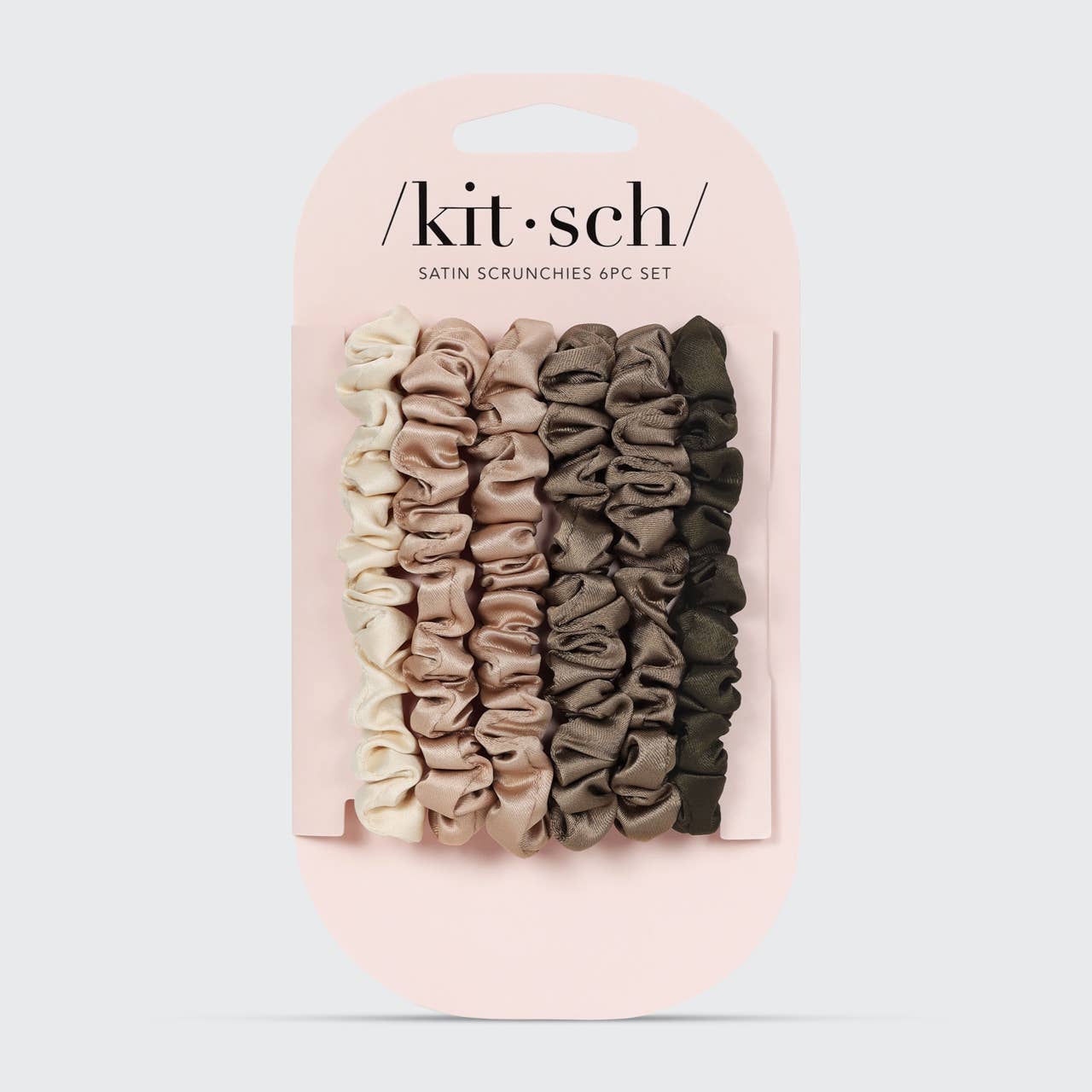 Set of satin scrunchies in various colors on a pink 'kit·sch' branded card.