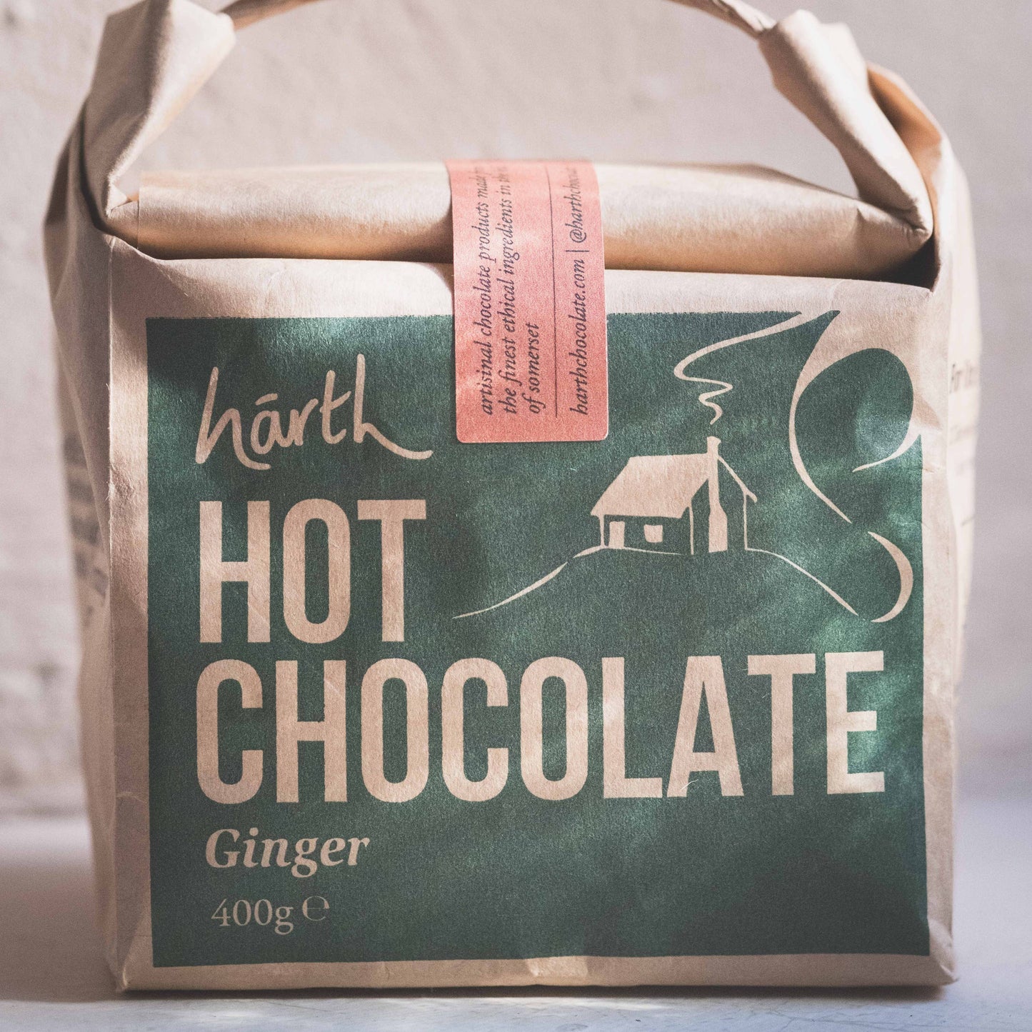 Packaged hot chocolate with a rustic design on a neutral background