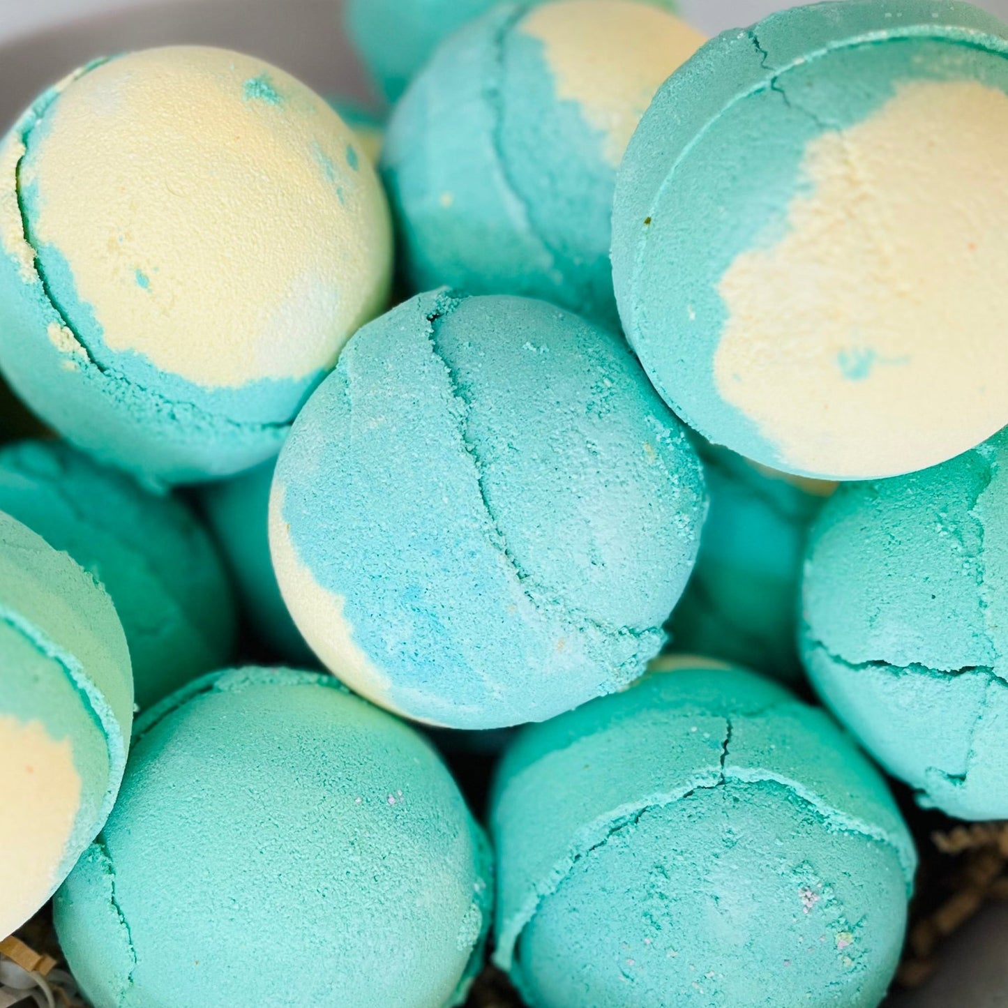 A selection of bath bombs, each with a teal and cream pattern.
