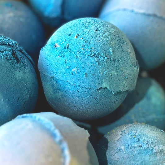 A close-up of multiple bath bombs, with a textured deep blue appearance.