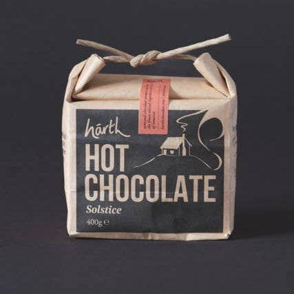 Box of hot chocolate with a rustic design on a dark background