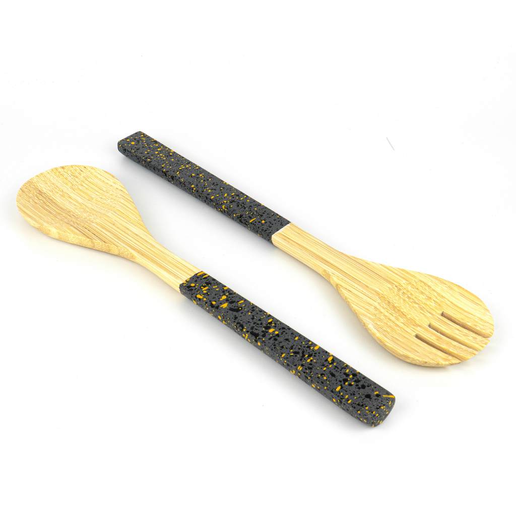 Wooden spoon and fork set with black speckled handles on a white background