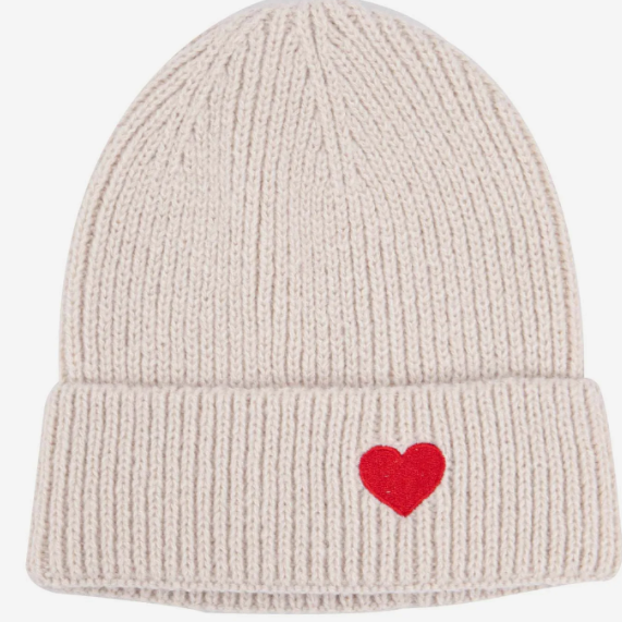 Beige knit beanie with a red heart on a white background