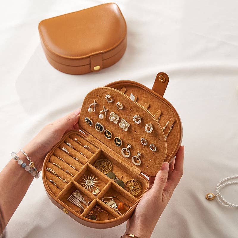 Brown jewelry organizer with jewelry items on a white background