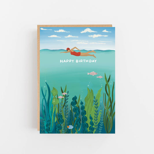Birthday card with a person swimming underwater and 'Happy Birthday' text on a blue background.