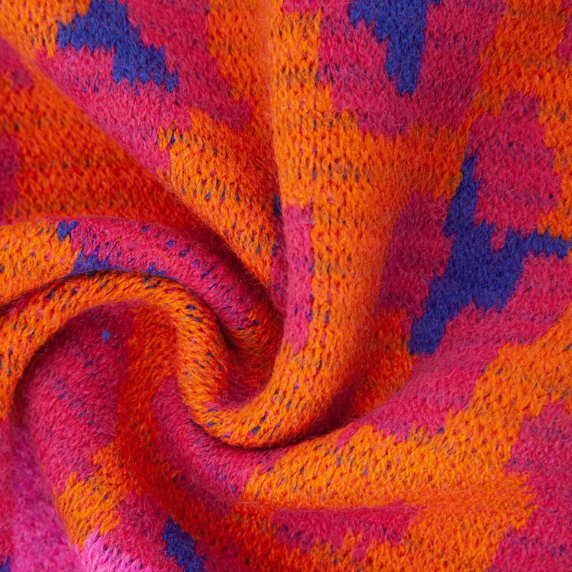 Close-up of a knitted fabric with pink and orange pattern