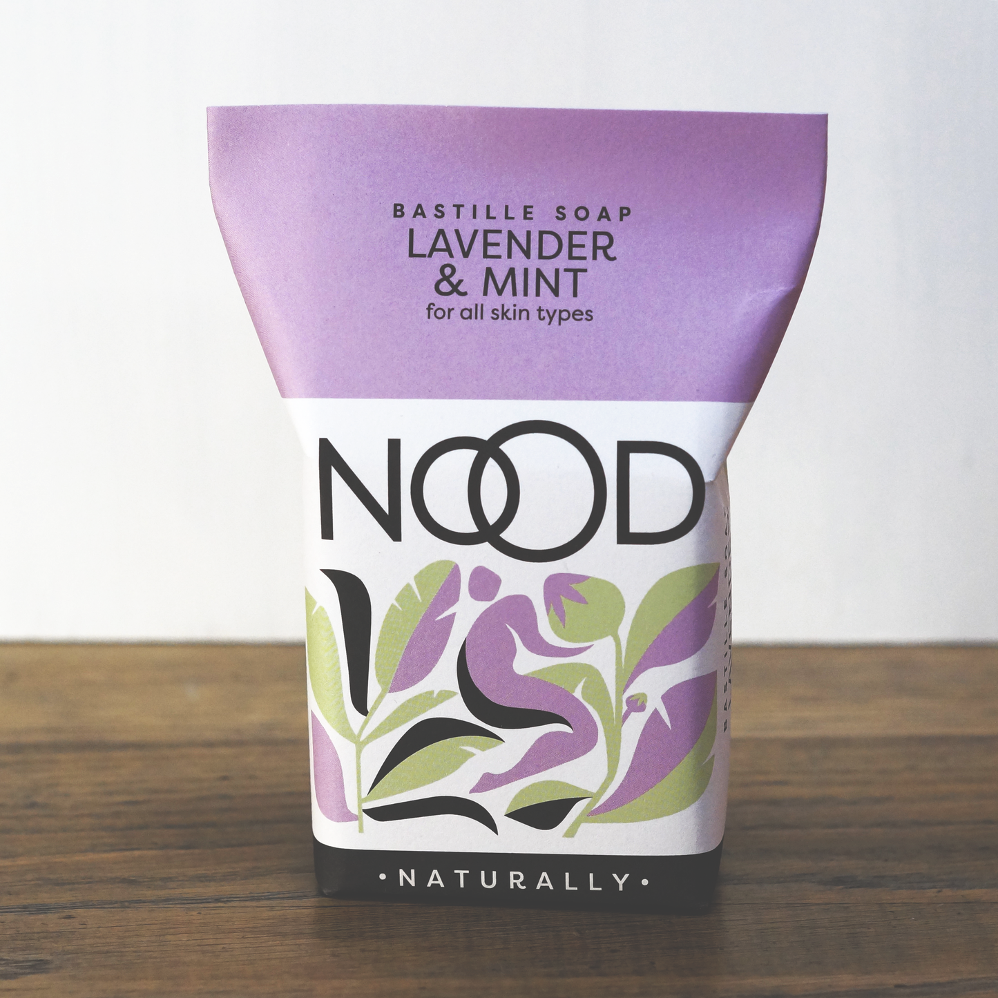 Packaged bar soap with lavender and mint label, indicating it is suitable for all skin types and free from harsh ingredients.