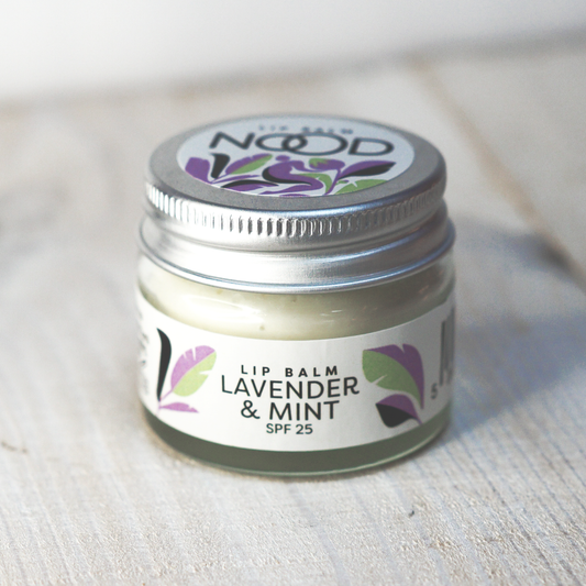 A glass jar of NOOD lip balm, lavender and mint flavour with SPF 25. Created by NOOD Stores.