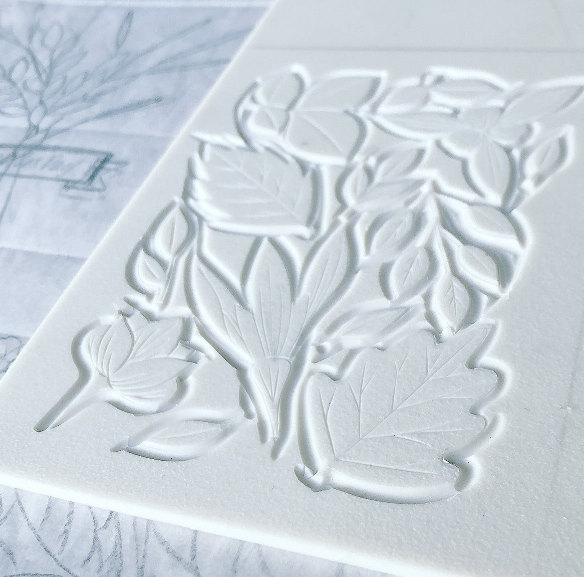 White embossed floral design on a textured surface