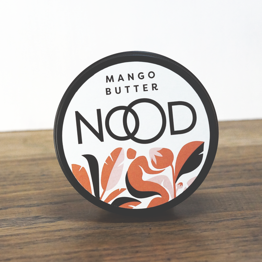 A black aluminium tub of Mango Butter with the branding of NOOD Stores on it. The sticker also has a decorative abstract pattern on it.