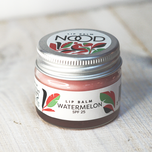 A small glass jar of red watermelon flavoured lip balm, with SPF 25, made by NOOD Stores.