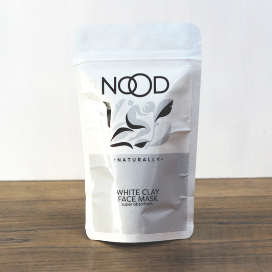 A packaged NOOD Stores Kaolin Clay Mask, labeled as White Clay Face Mask, on a light surface with a neutral background.