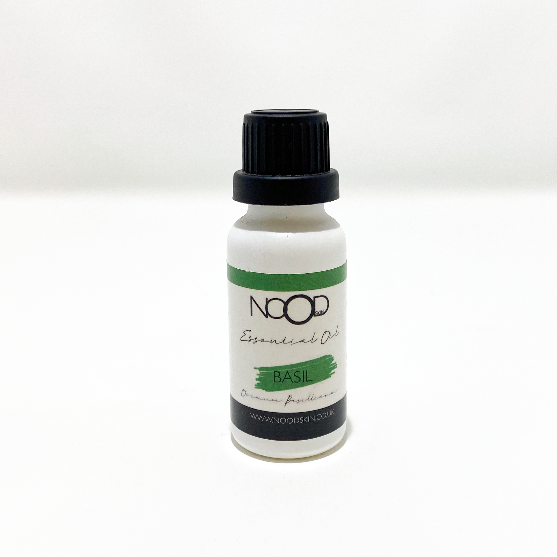 A bottle of NOOD Basil essential oil with a dropper, on a white background.