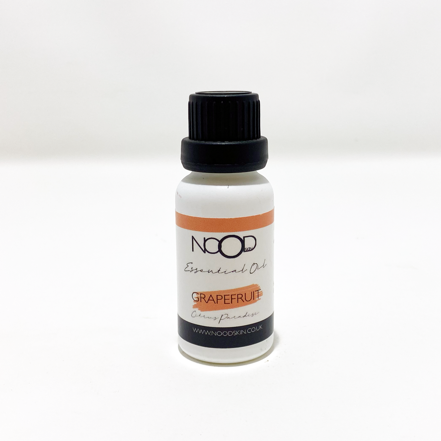 A small white bottle of Grapefruit Essential Oil from 'NOOD', against a white background.