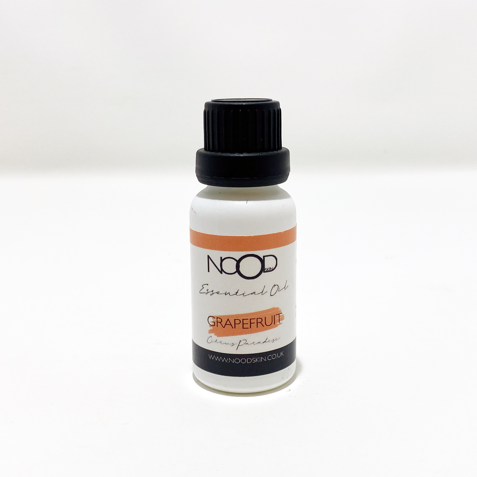 A small white bottle of Grapefruit Essential Oil from 'NOOD', against a white background.