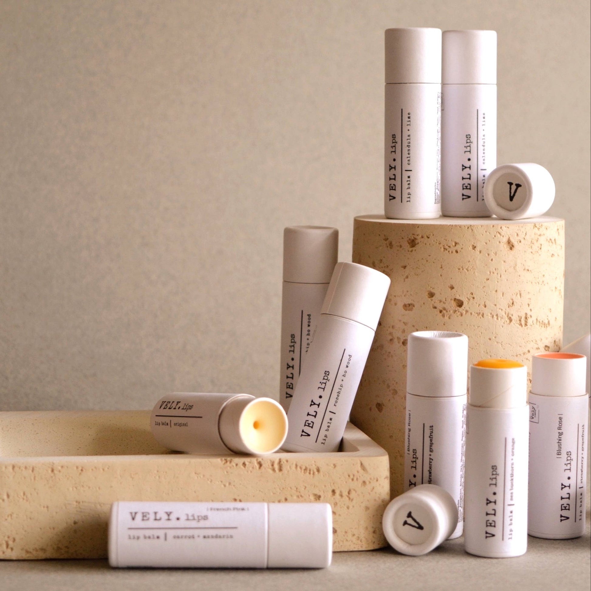 Collection of VELY skincare products on a neutral background