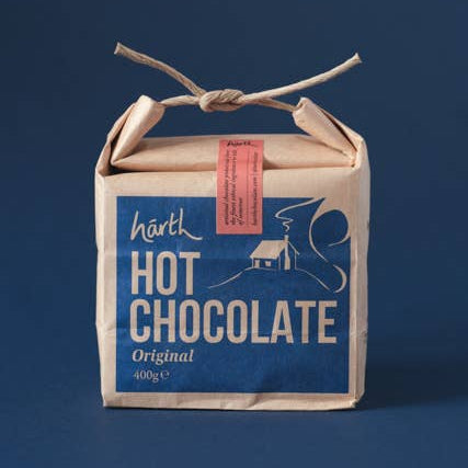 Box of hot chocolate with a blue label on a dark background