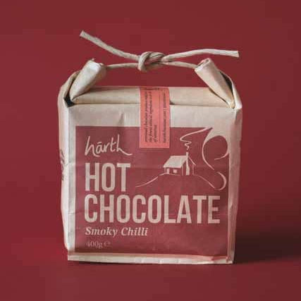 Packaged hot chocolate with a red label on a red background