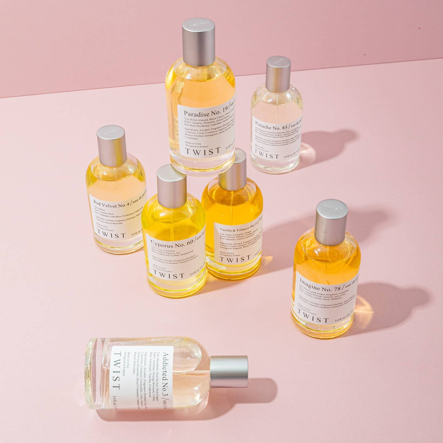 Collection of bottles with labels on a pink background