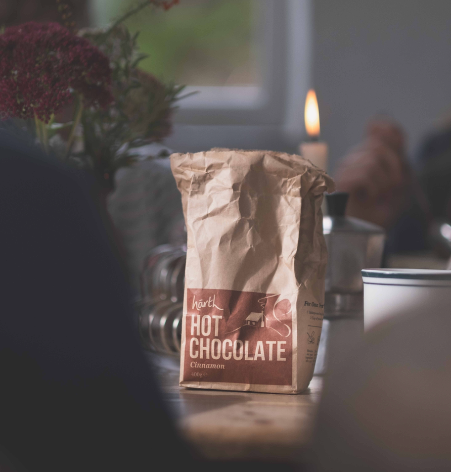 Härtl Hot Chocolate bag on a table with blurred background