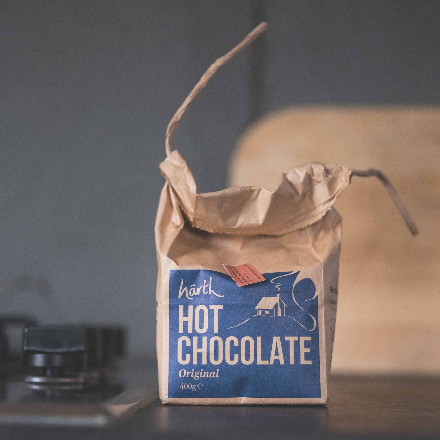 Bag of hot chocolate on a rustic surface with a blurred background