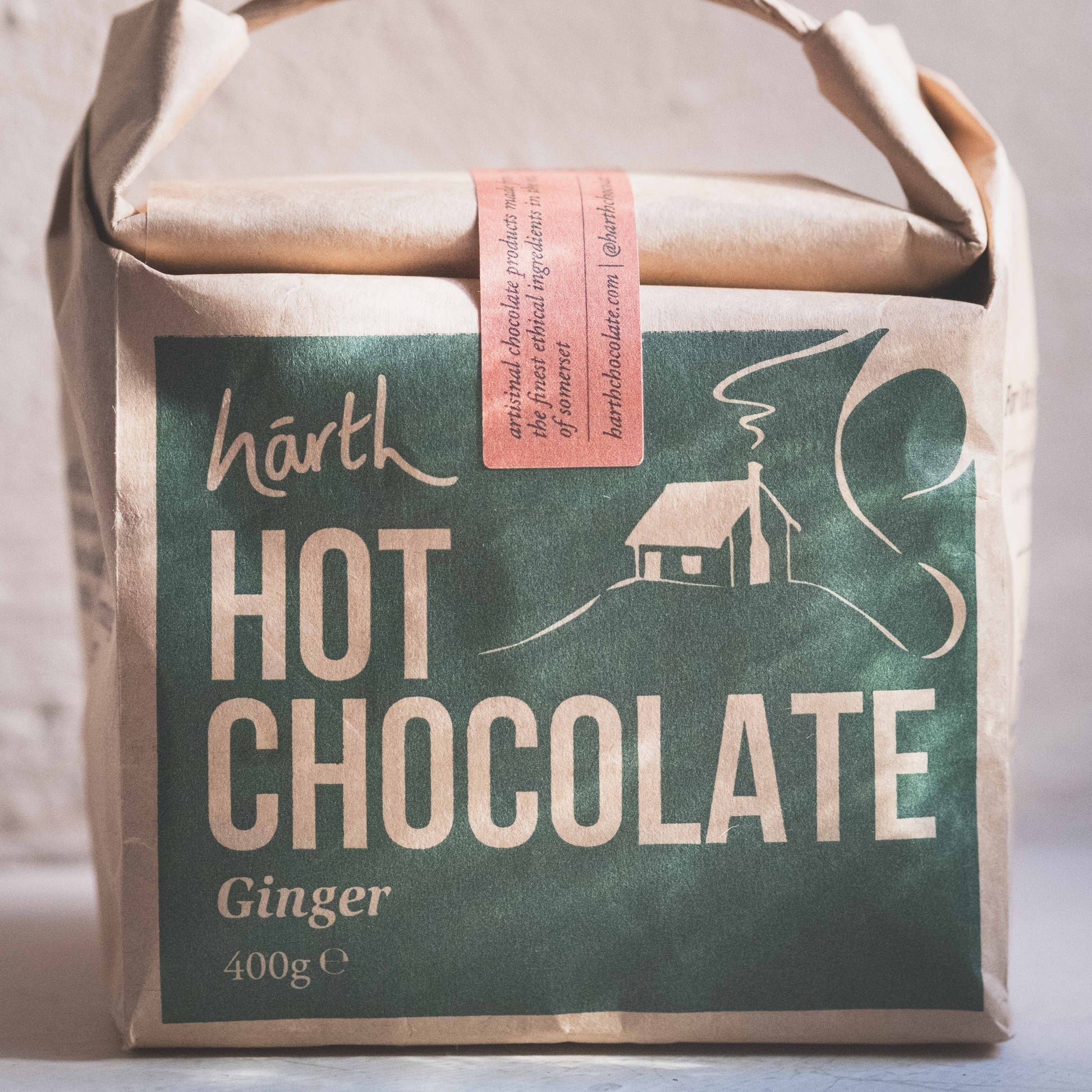 Packaged hot chocolate with a rustic design on a neutral background