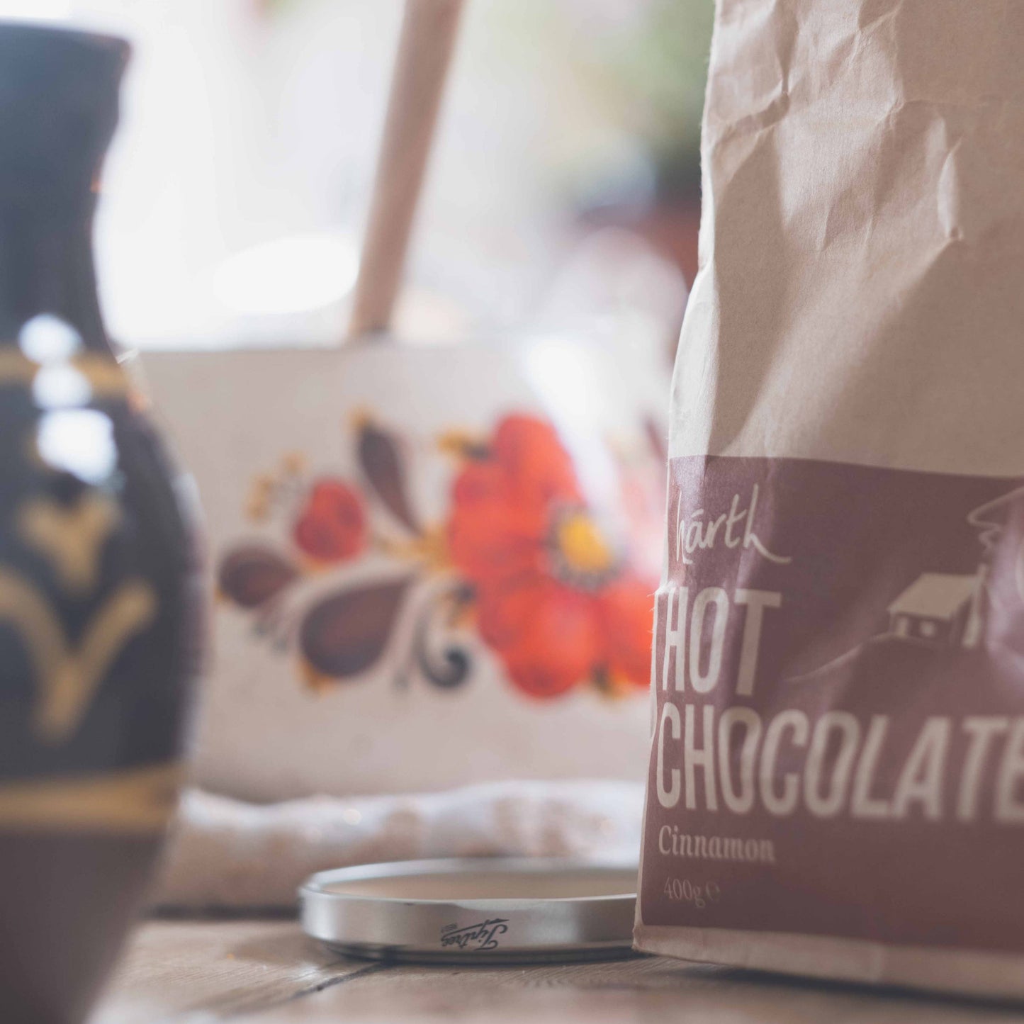 Bag of hot chocolate mix on a table with a blurred background