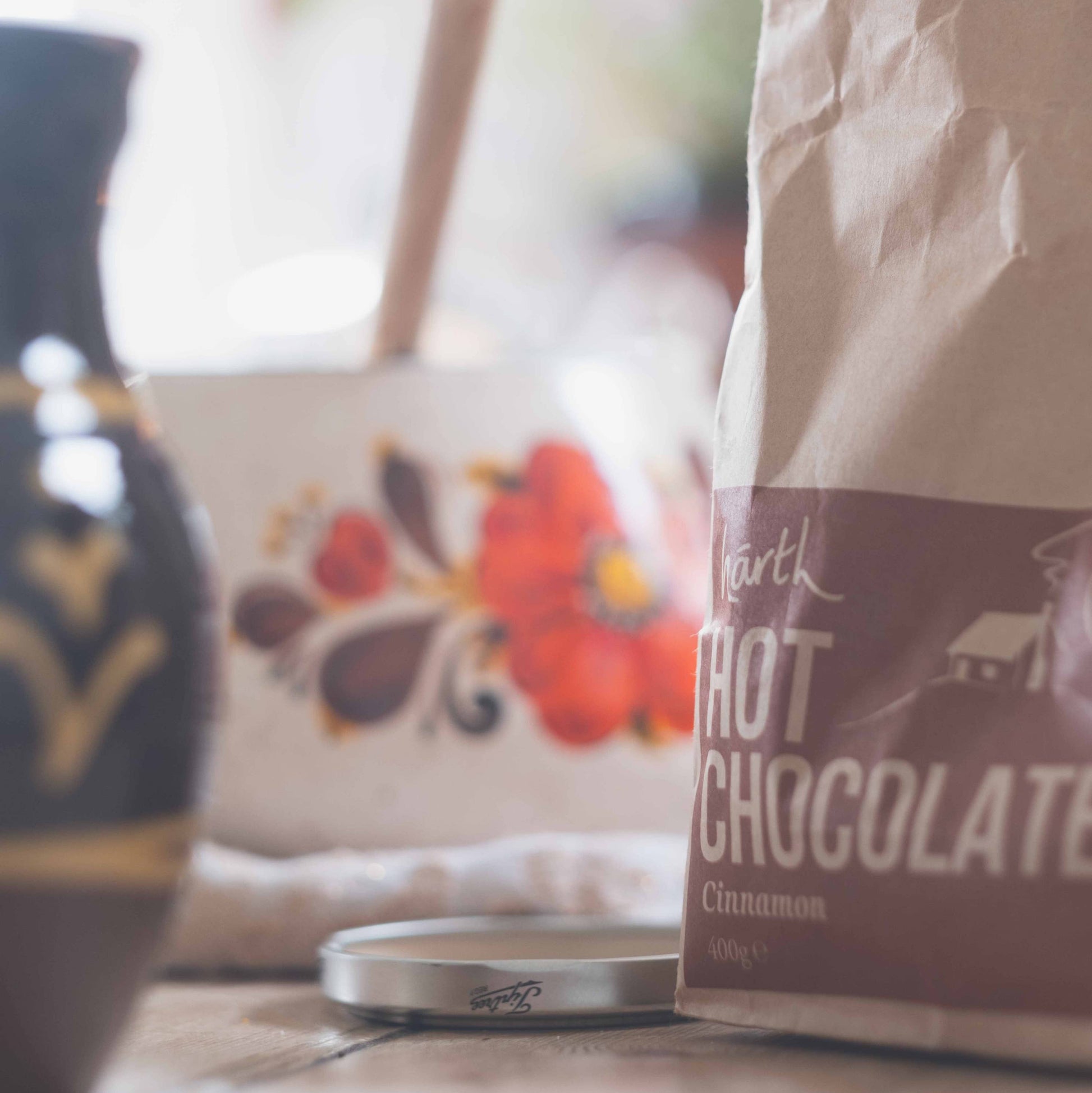 Bag of hot chocolate mix on a table with a blurred background