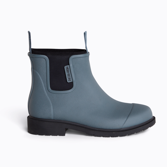 Blue rubber boot with black sole on a white background