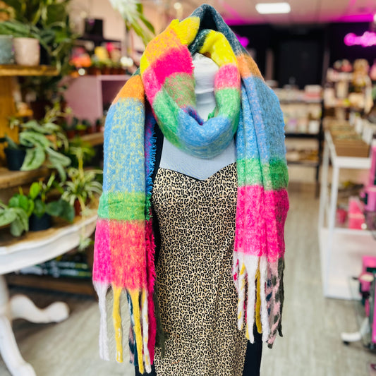 Mannequin wearing a colorful scarf in a store setting