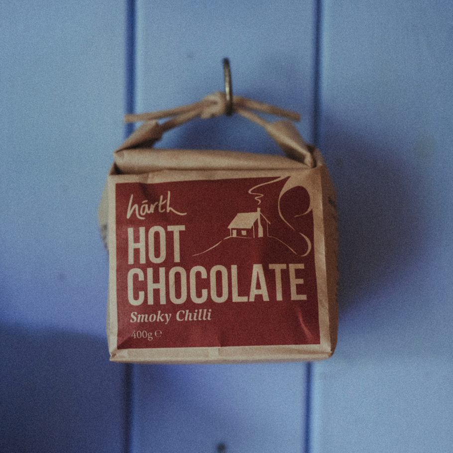 Box of HARTH Hot Chocolate Smoky Chilli on a blue background