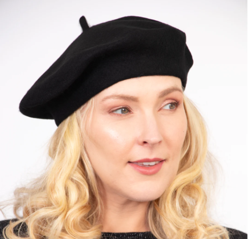Woman wearing a black beret against a white background