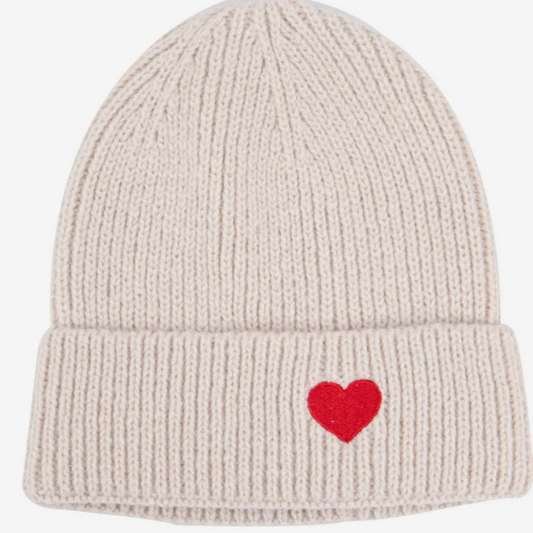 Beige knit beanie with a red heart on a white background