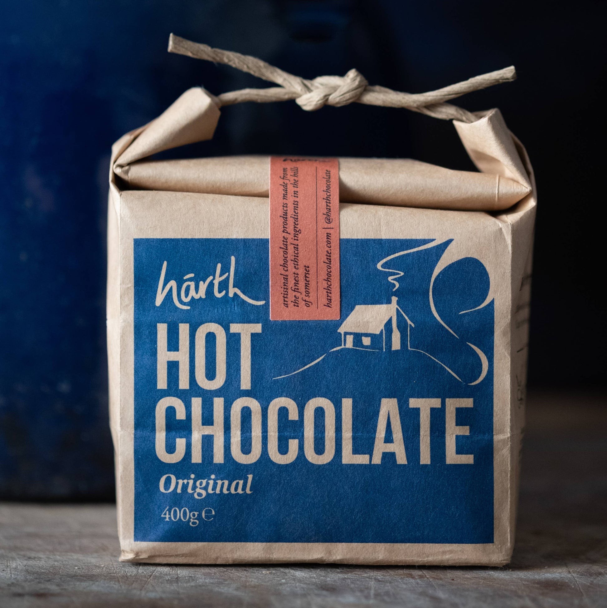 Box of Harth Hot Chocolate with a blue label and brown paper wrapping.
