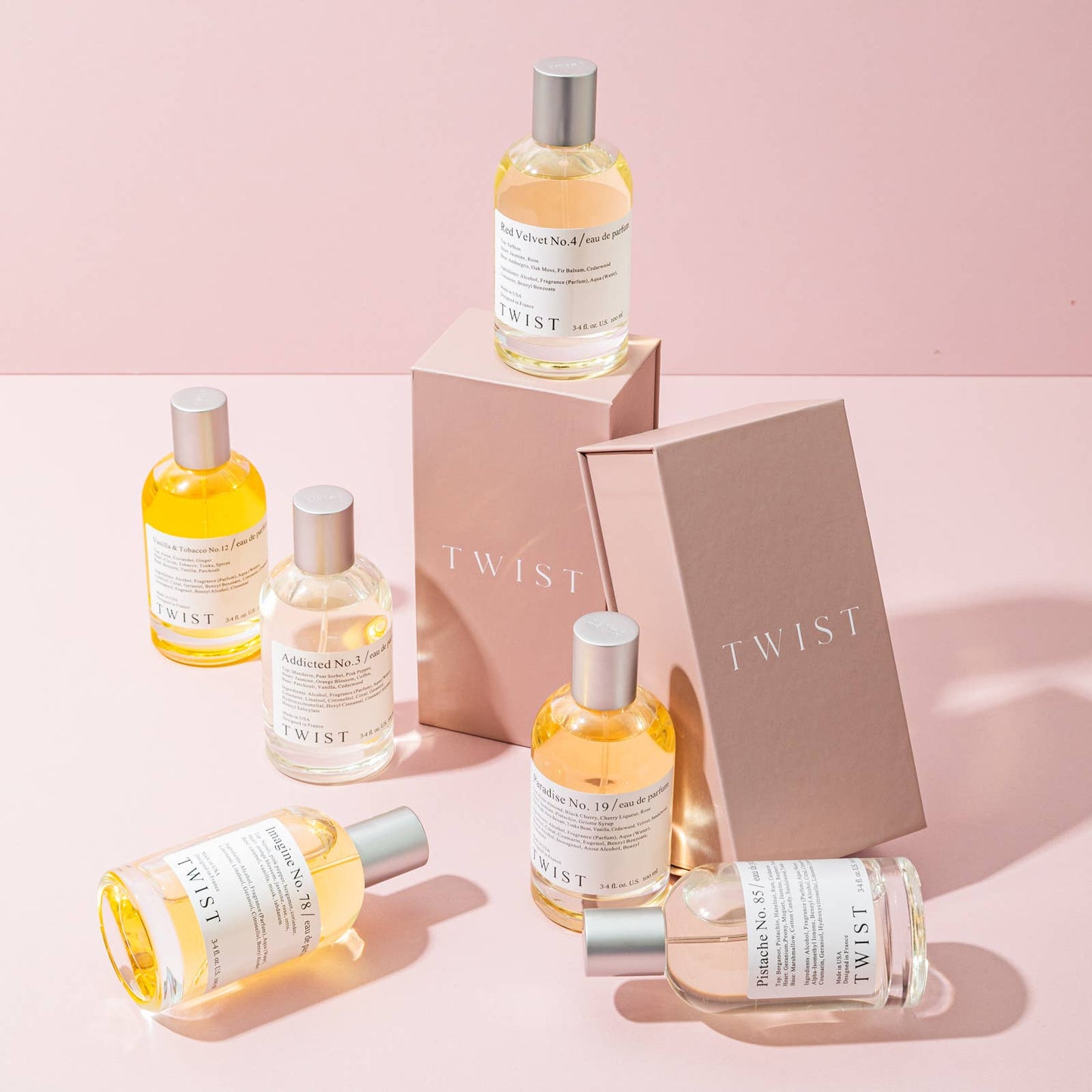 Collection of Twist skincare products on a pink background