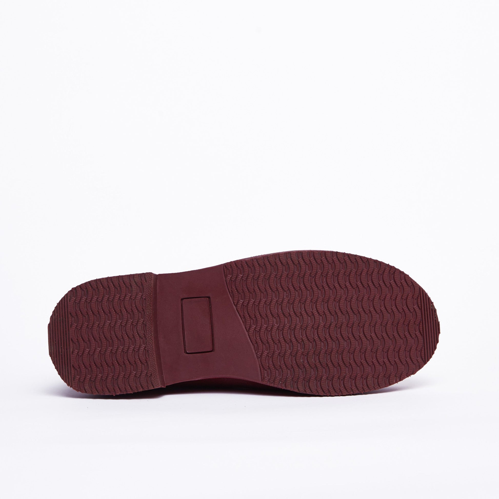 Maroon sole of a shoe on a white background