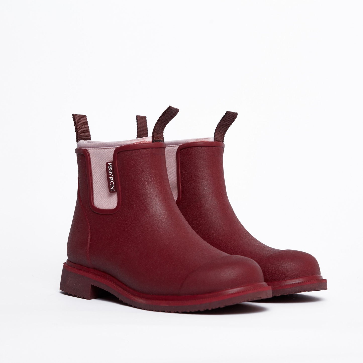Pair of red rain boots on a white background